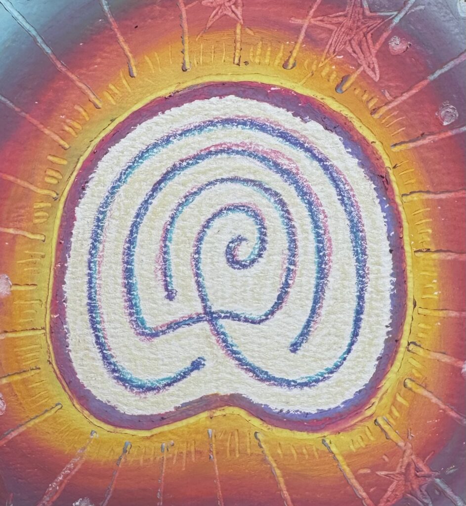 Colorful oil pastel image of a hoofprint shaped labryrinth spiral